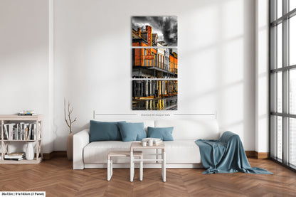 a living room with a white couch and a painting on the wall
