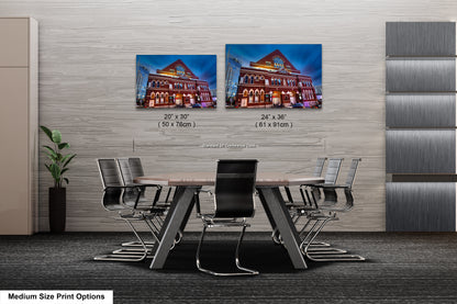 a dining room table with chairs and a picture of a house on the wall