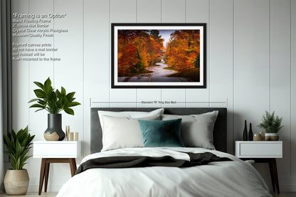 a bedroom with a bed and a picture hanging on the wall