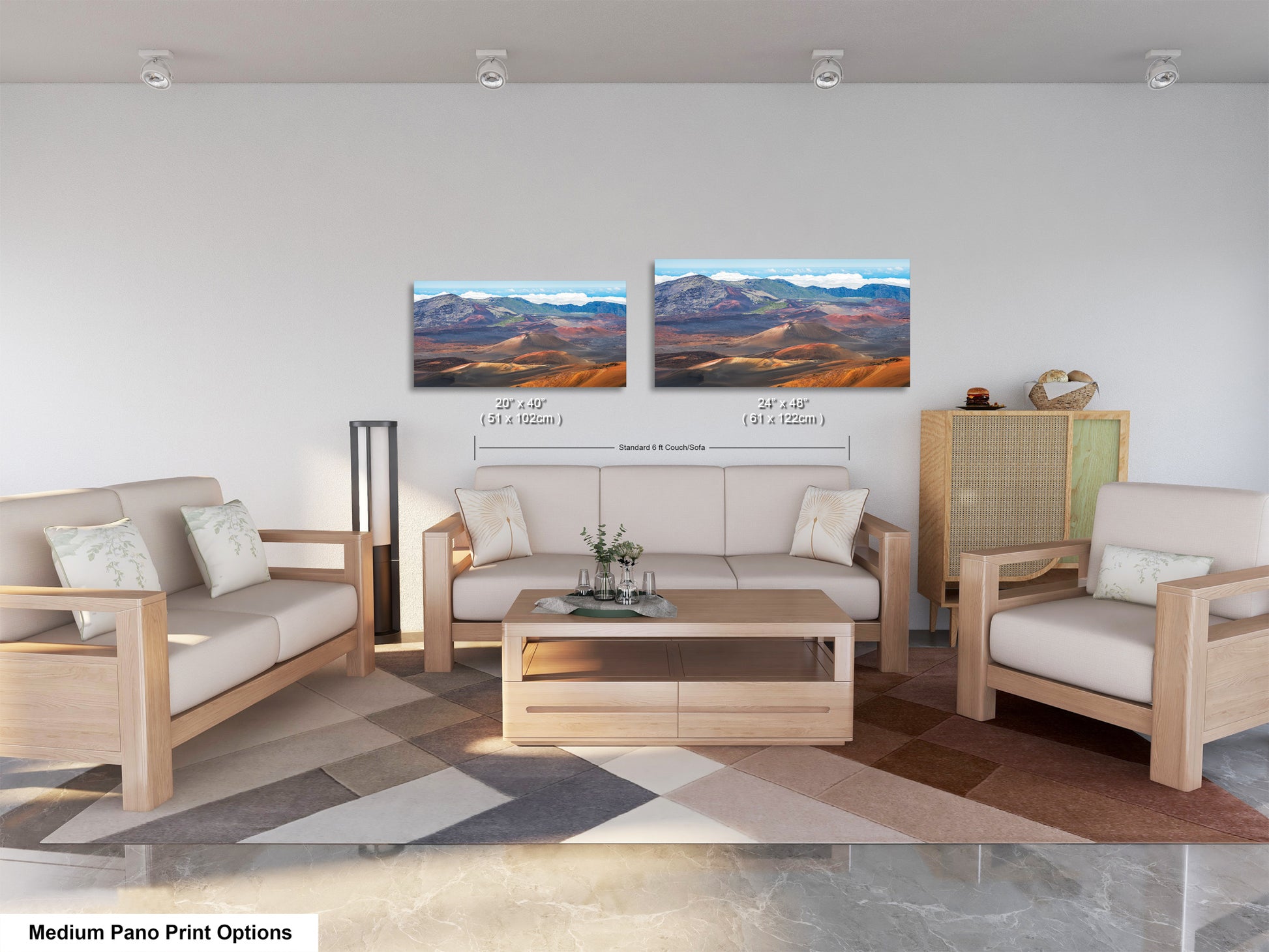 a modern living room with a sofa, two chairs, and a coffee table. There are two framed landscape paintings on the wall above the seating area, depicting mountains and a desert scene. The room has a neutral color scheme with white walls and a wooden floor.