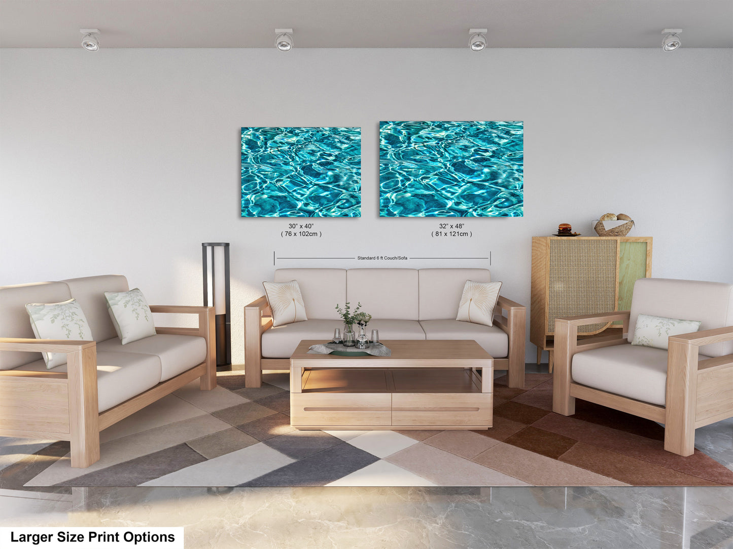a modern living room with a white sofa, two chairs, and a coffee table. The room has a geometric patterned rug on the floor. Two framed prints of water are displayed on the wall above the seating area, creating a cohesive and stylish design.