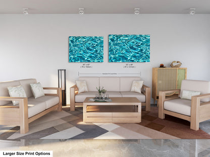 a modern living room with a white sofa, two chairs, and a coffee table. The room has a geometric patterned rug on the floor. Two framed prints of water are displayed on the wall above the seating area, creating a cohesive and stylish design.