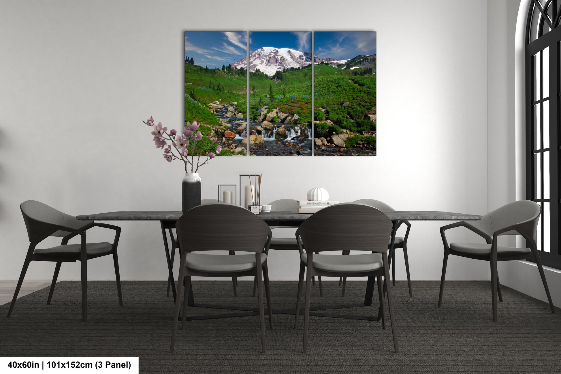 a dining room table with chairs and a painting on the wall