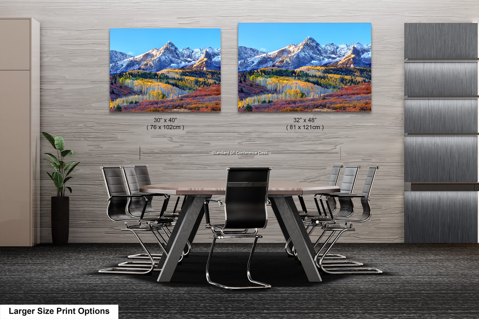 a dining room table with chairs and a painting of mountains