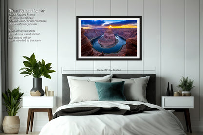 a bedroom with a bed and a picture hanging on the wall