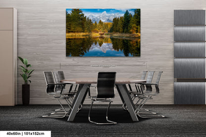 a dining room table with chairs and a painting on the wall