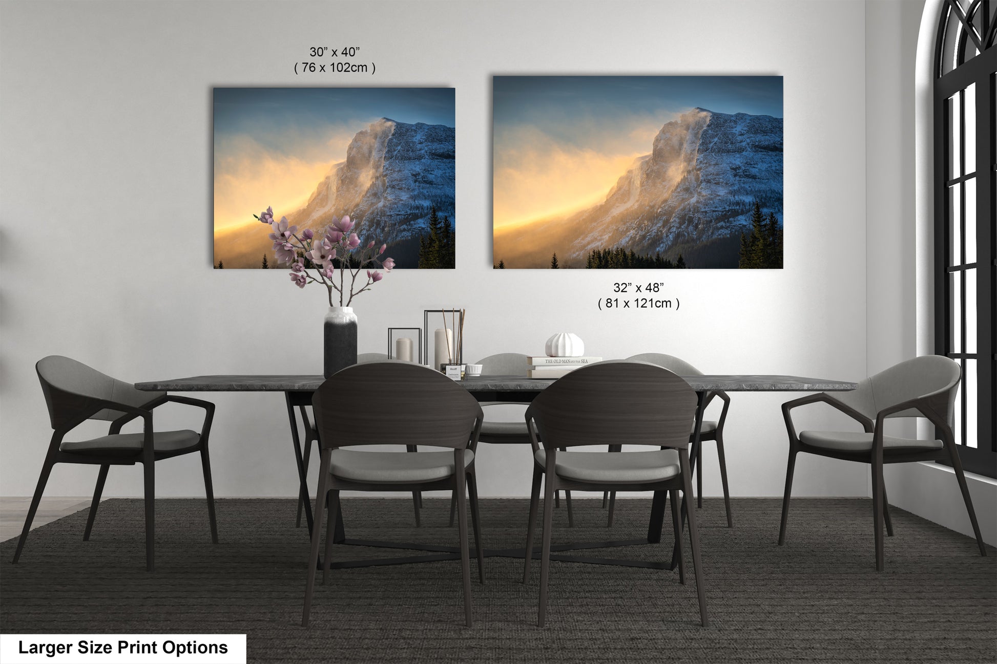 a dining table with four chairs and a vase of flowers
