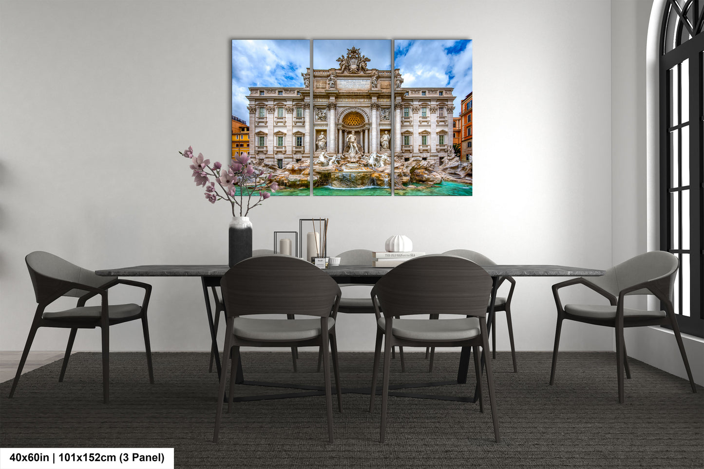 a dining room table with chairs and a painting on the wall