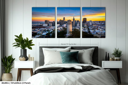 a bedroom with a bed and three pictures on the wall