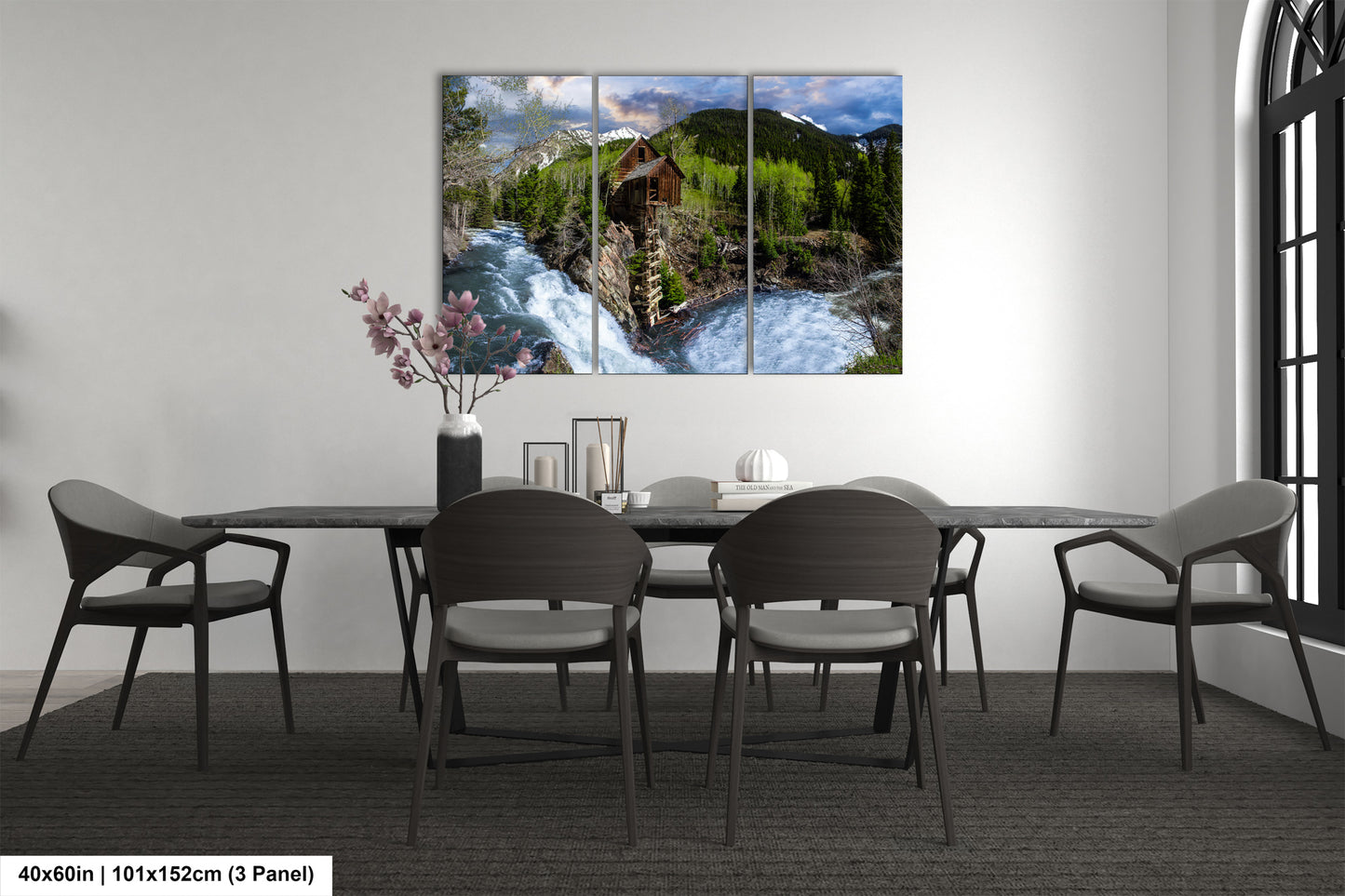 a dining room table with chairs and a painting on the wall