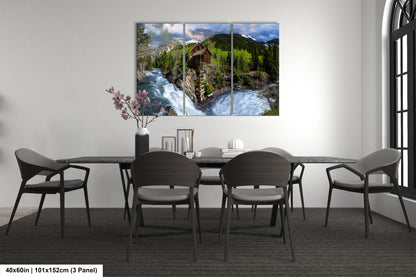 a dining room table with chairs and a painting on the wall