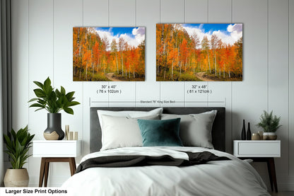 a bedroom with a bed and two pictures on the wall