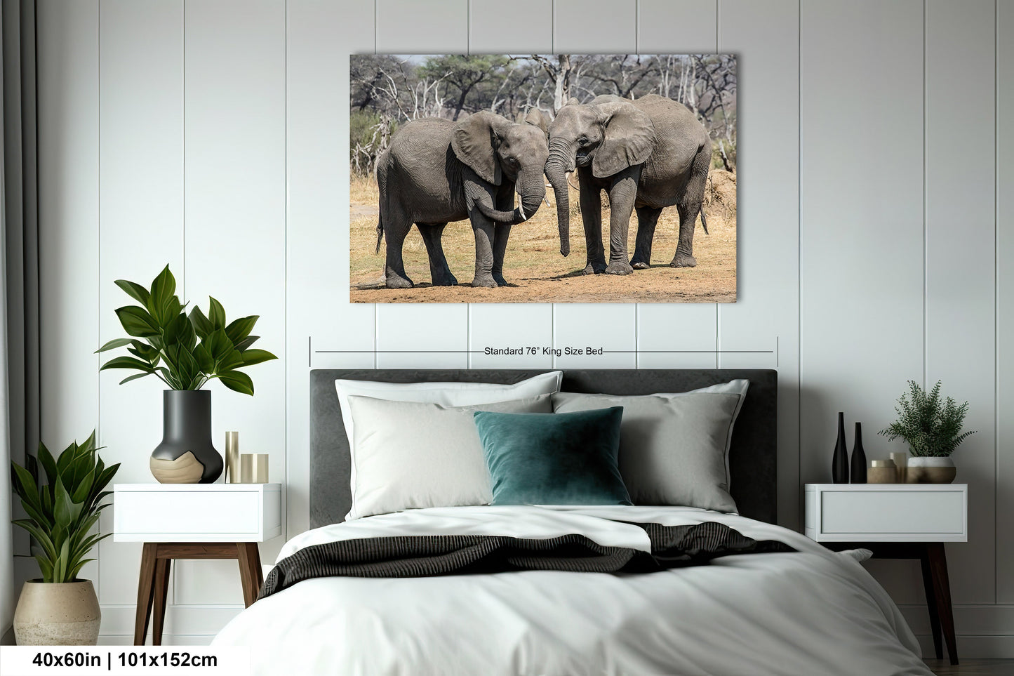 a couple of elephants standing next to each other on a bed