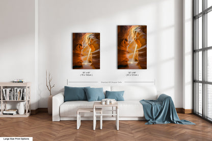 a living room with a white couch and two paintings on the wall