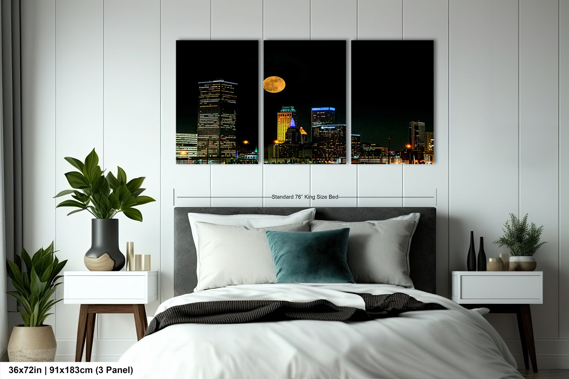 a bed room with a neatly made bed and a night time view of a city