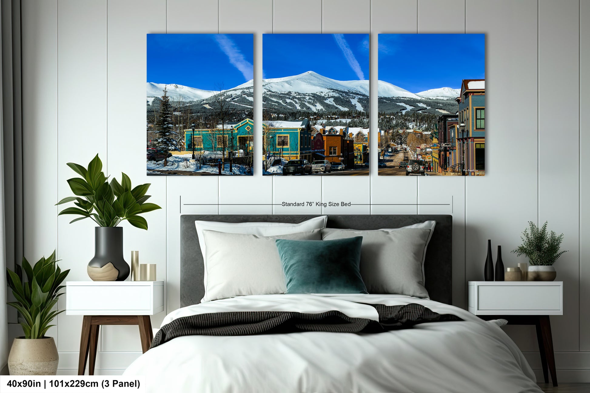 a bedroom with a large bed and three paintings on the wall