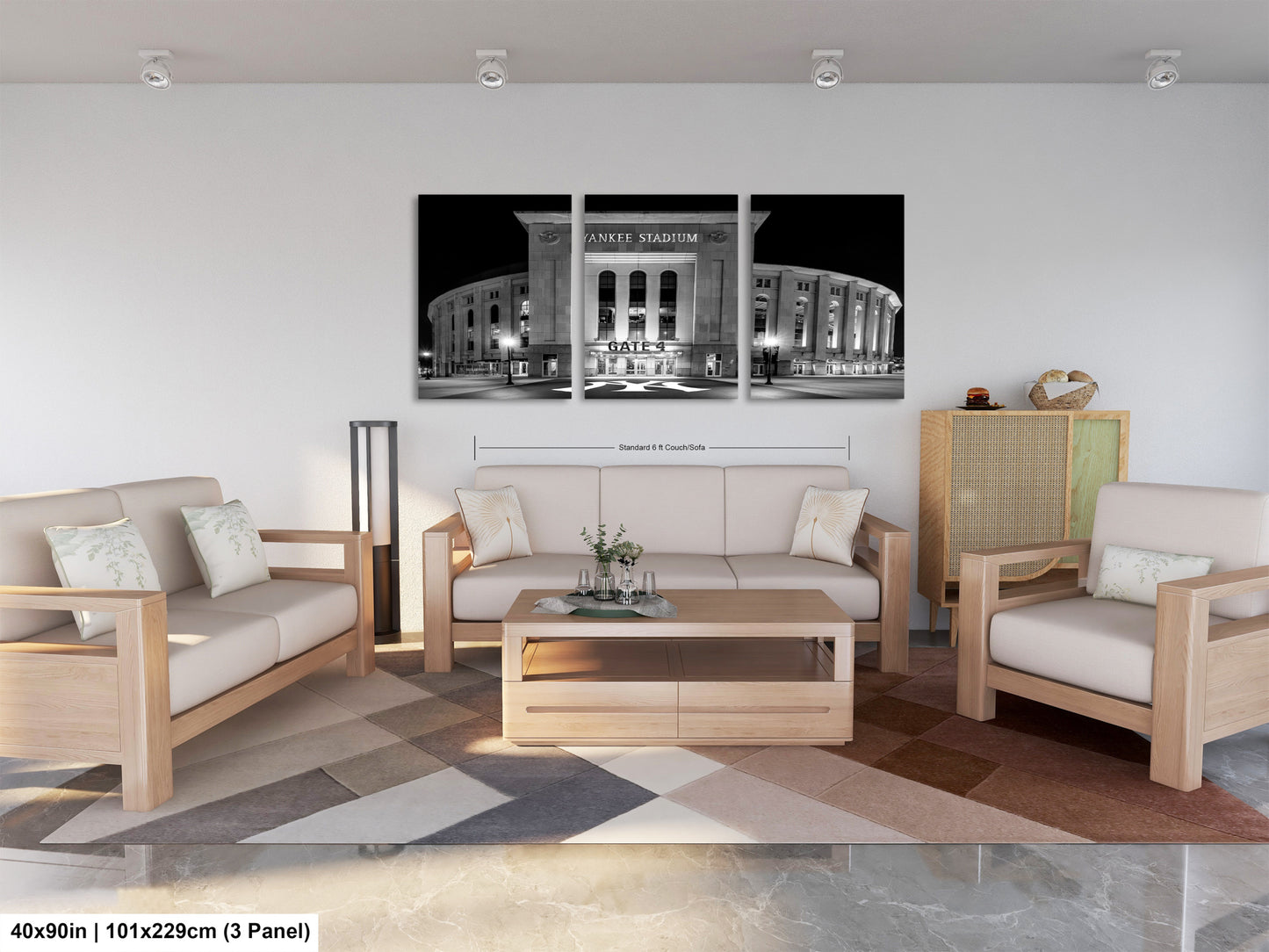 The image is a modern living room with a large black and white photograph of Yankee Stadium as the focal point. The room is furnished with a sofa, two armchairs, and a coffee table, creating a comfortable and stylish space.