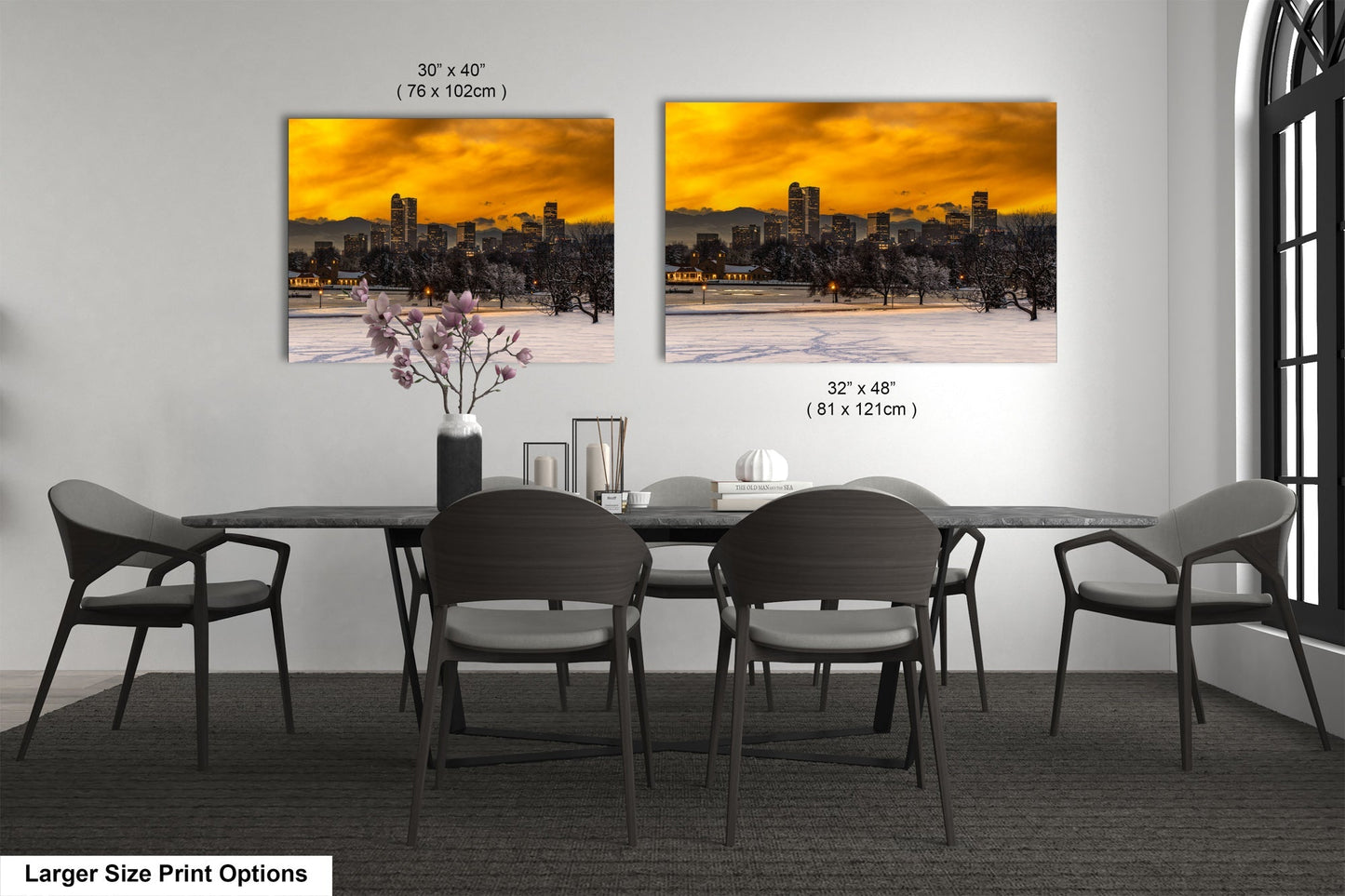 a dining room table with four chairs and a vase with flowers