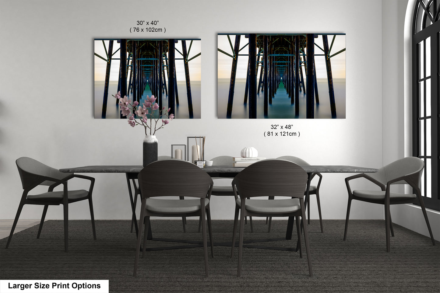 a dining room table with four chairs and a vase with flowers