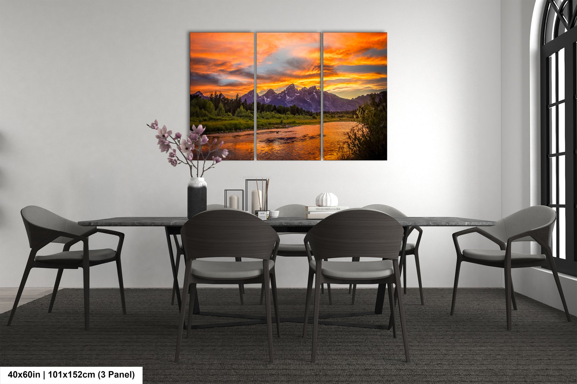 a dining room table with chairs and a painting on the wall