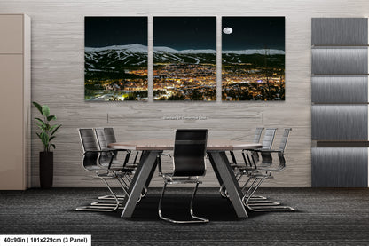 a dining room table with a view of a city at night