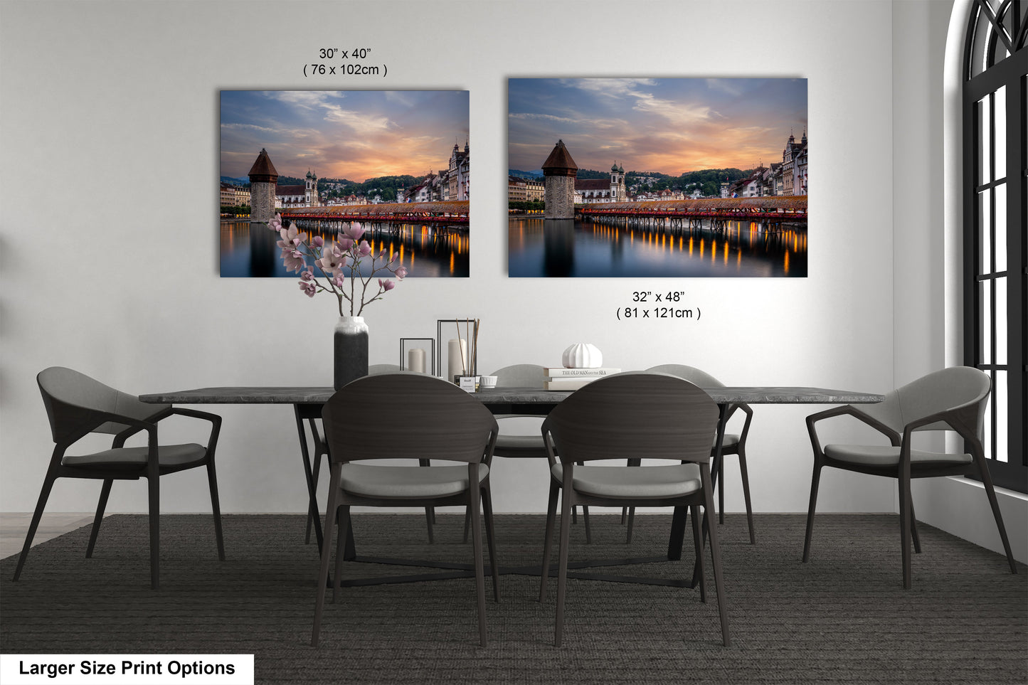 a dining room table with four chairs and two pictures on the wall