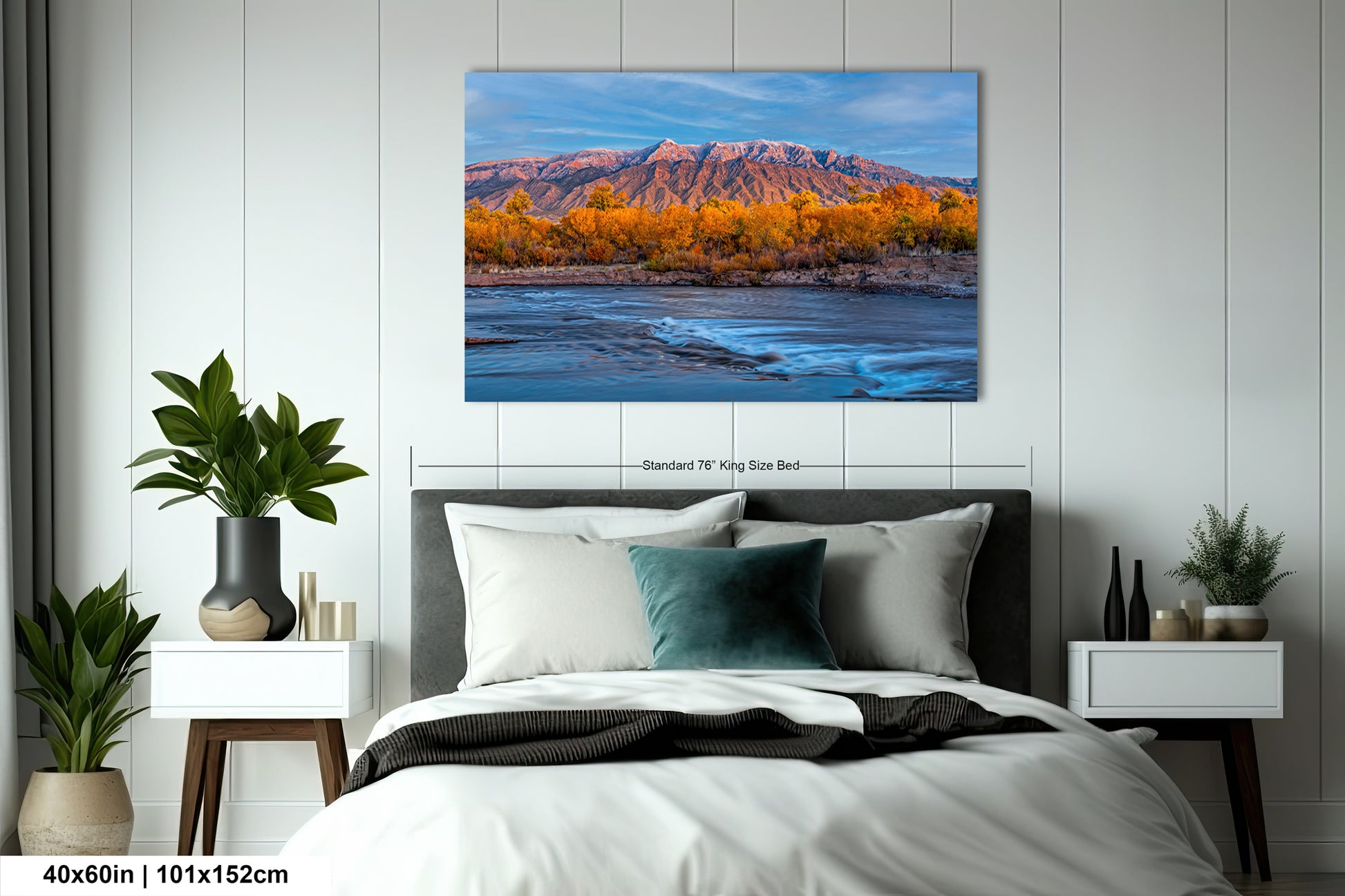 a bedroom with a bed and a painting on the wall