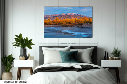 a bedroom with a bed and a painting on the wall