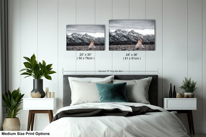 a bed with two pictures on the wall above it