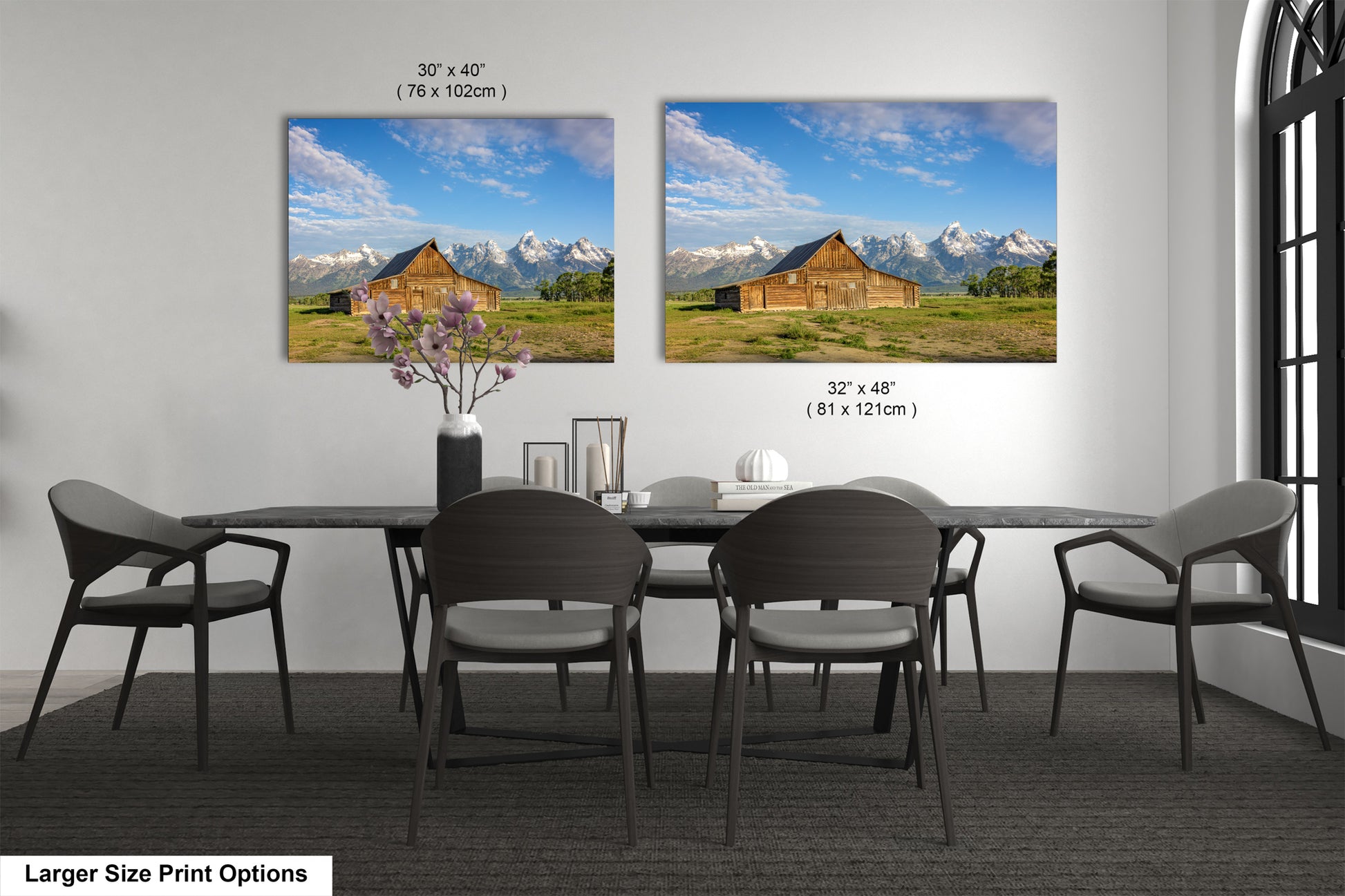 a dining room table with four chairs and a vase of flowers