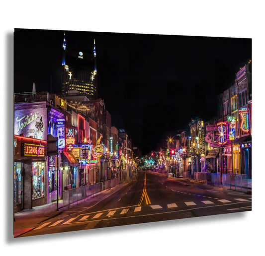 a city street at night with neon lights