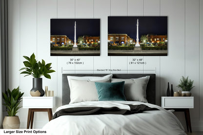 a bedroom with a bed and two pictures on the wall