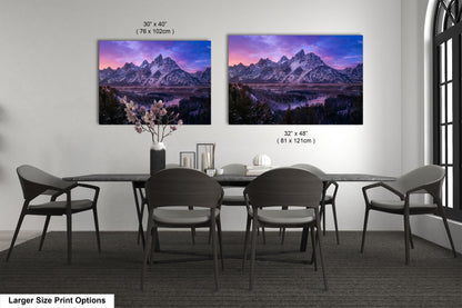 a dining room table with four chairs and a vase of flowers
