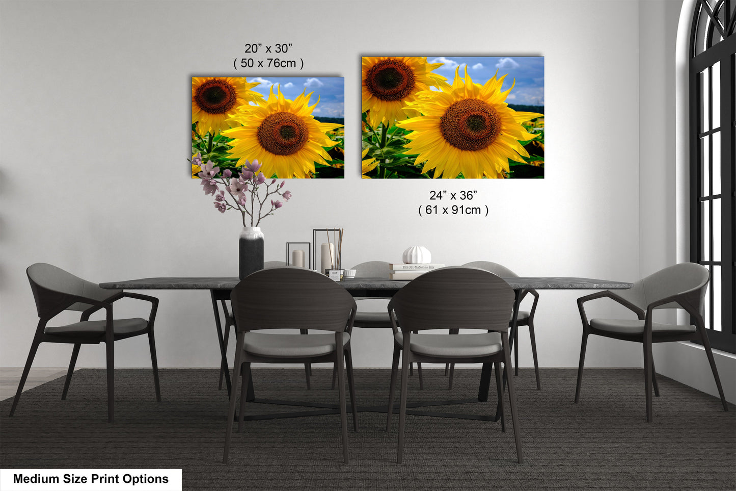 a dining room table with four chairs and a vase of sunflowers