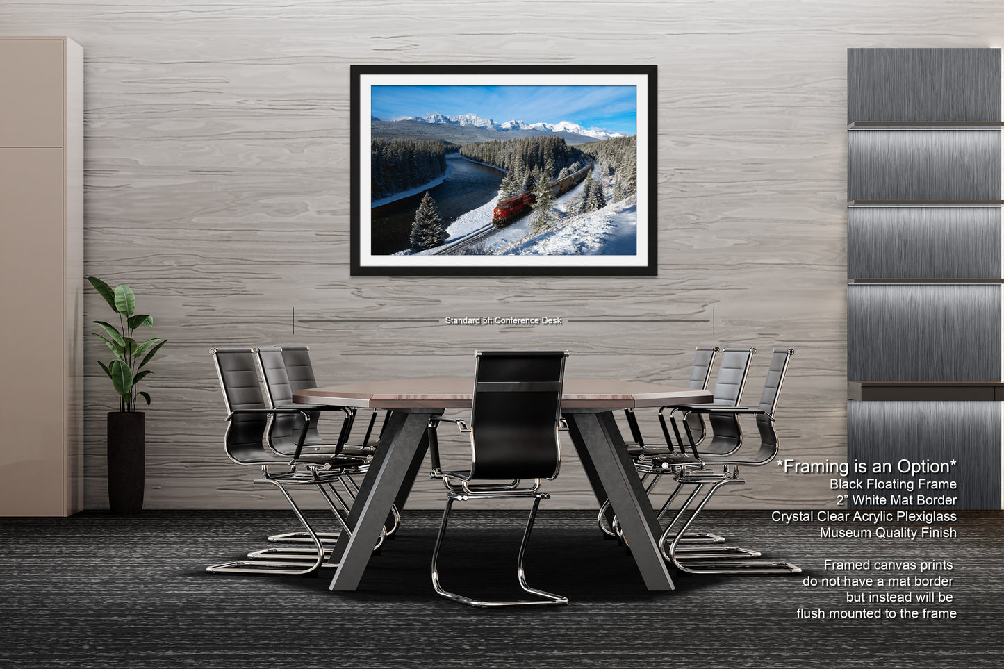 a modern office space with a large framed landscape photograph hanging on the wall above a wooden table surrounded by black chairs.