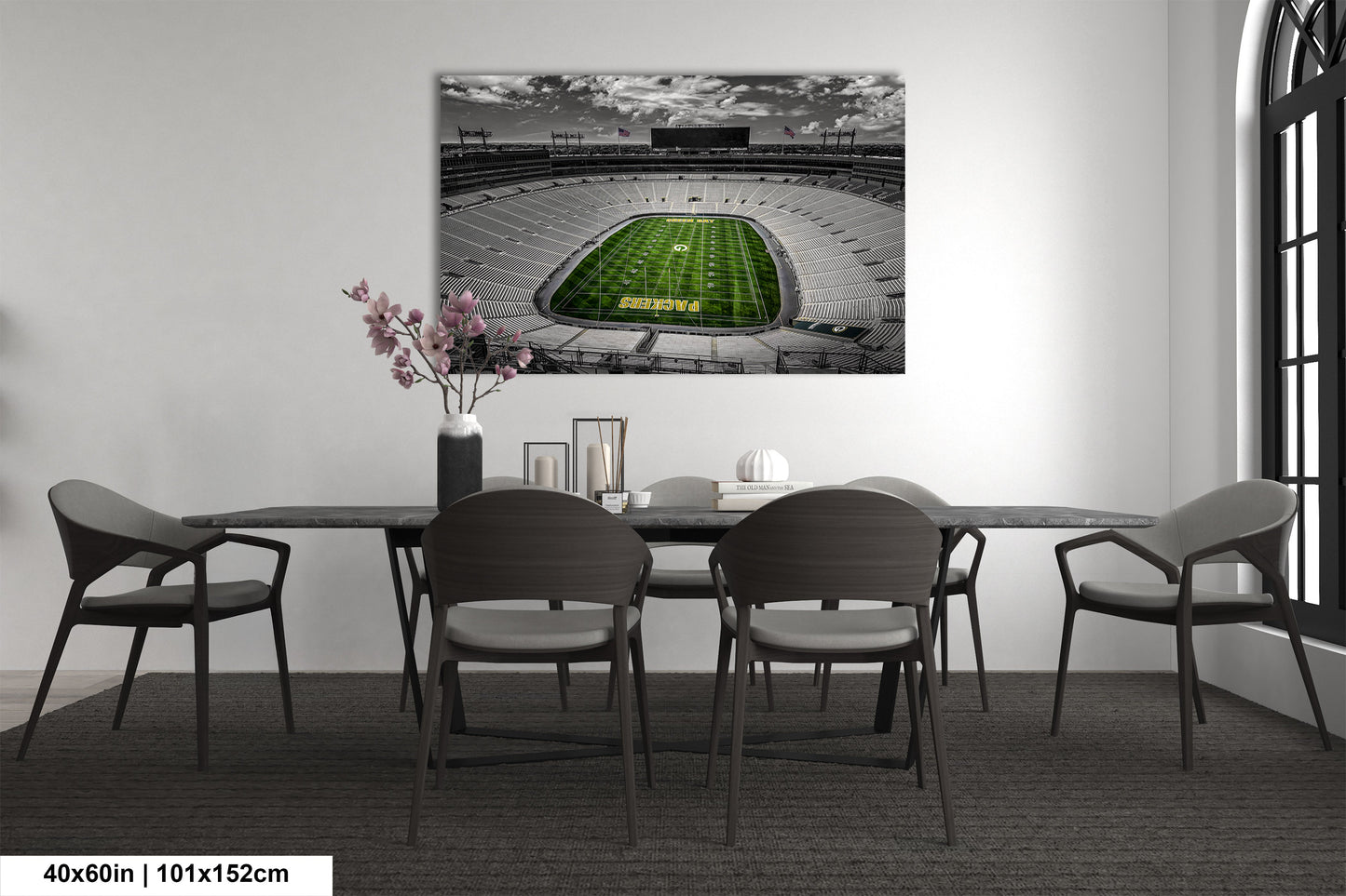 a dining room table with chairs and a painting of a football stadium