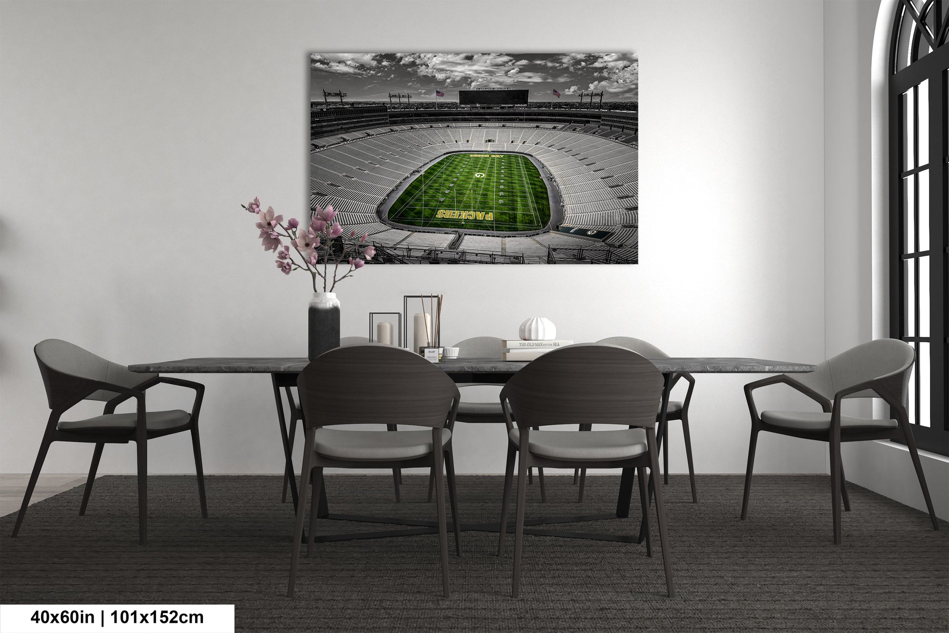 a dining room table with chairs and a painting of a football stadium
