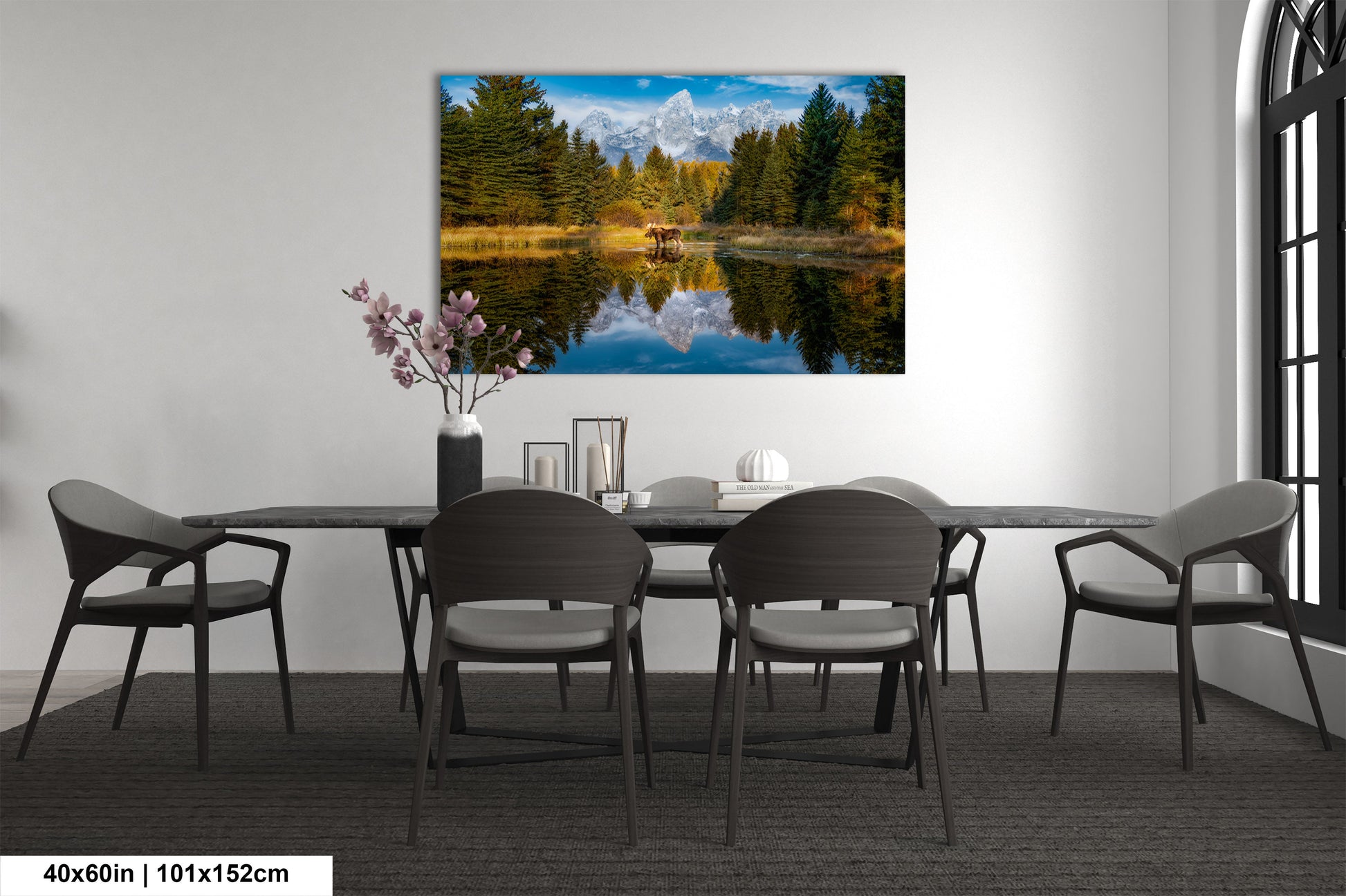 a dining room table with chairs and a painting on the wall