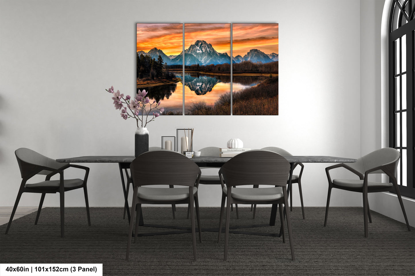 a dining room table with chairs and a painting on the wall
