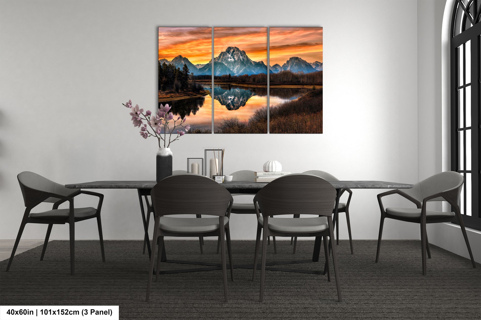 a dining room table with chairs and a painting on the wall