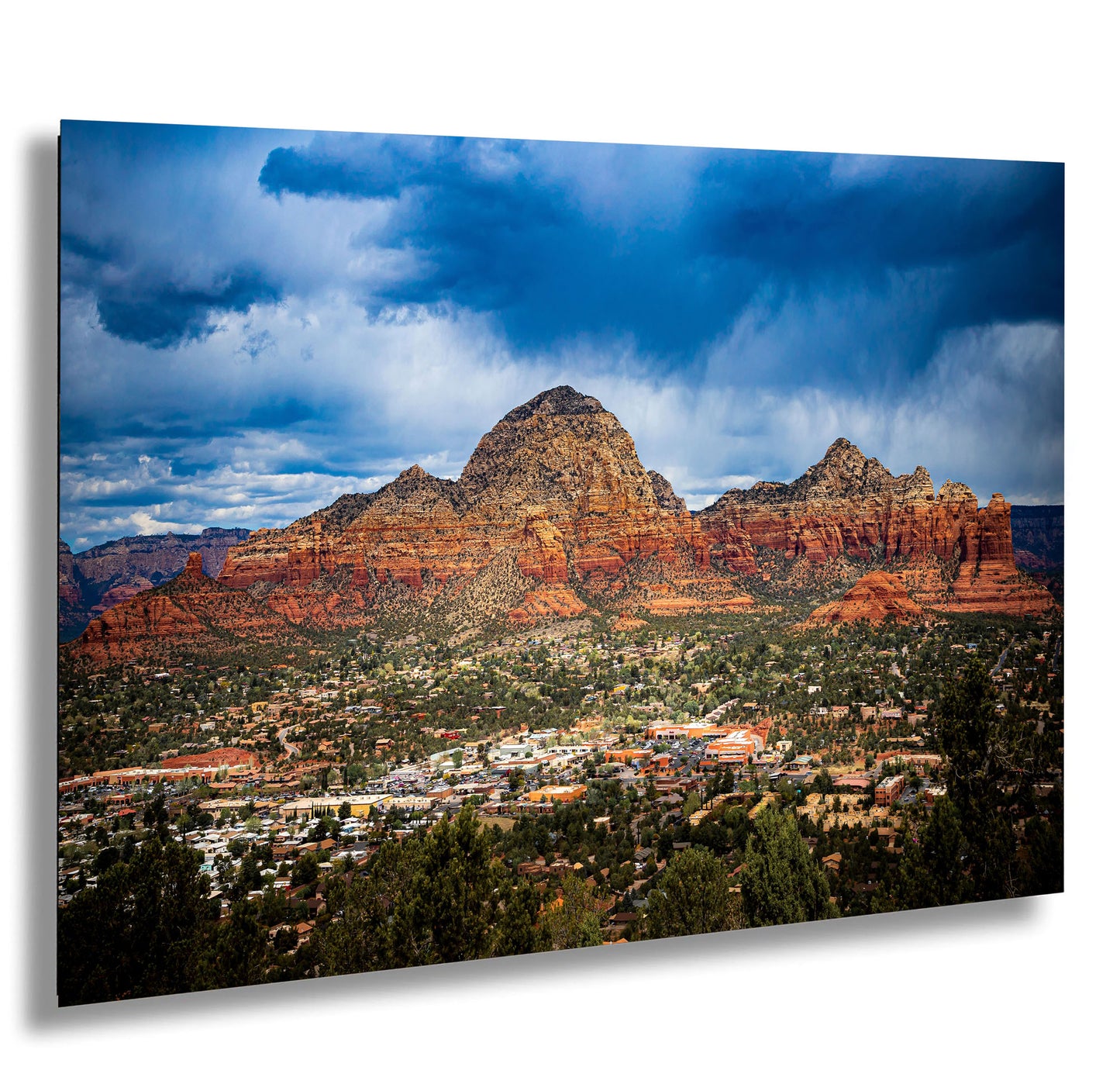 a scenic view of a city and mountains under a cloudy sky