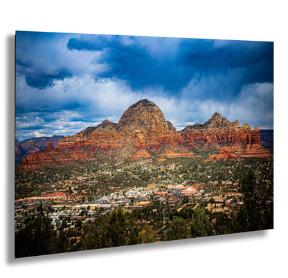 a scenic view of a city and mountains under a cloudy sky