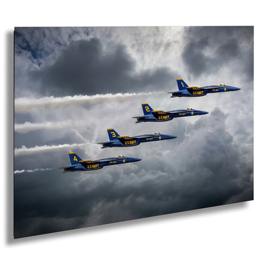 a group of fighter jets flying through a cloudy sky