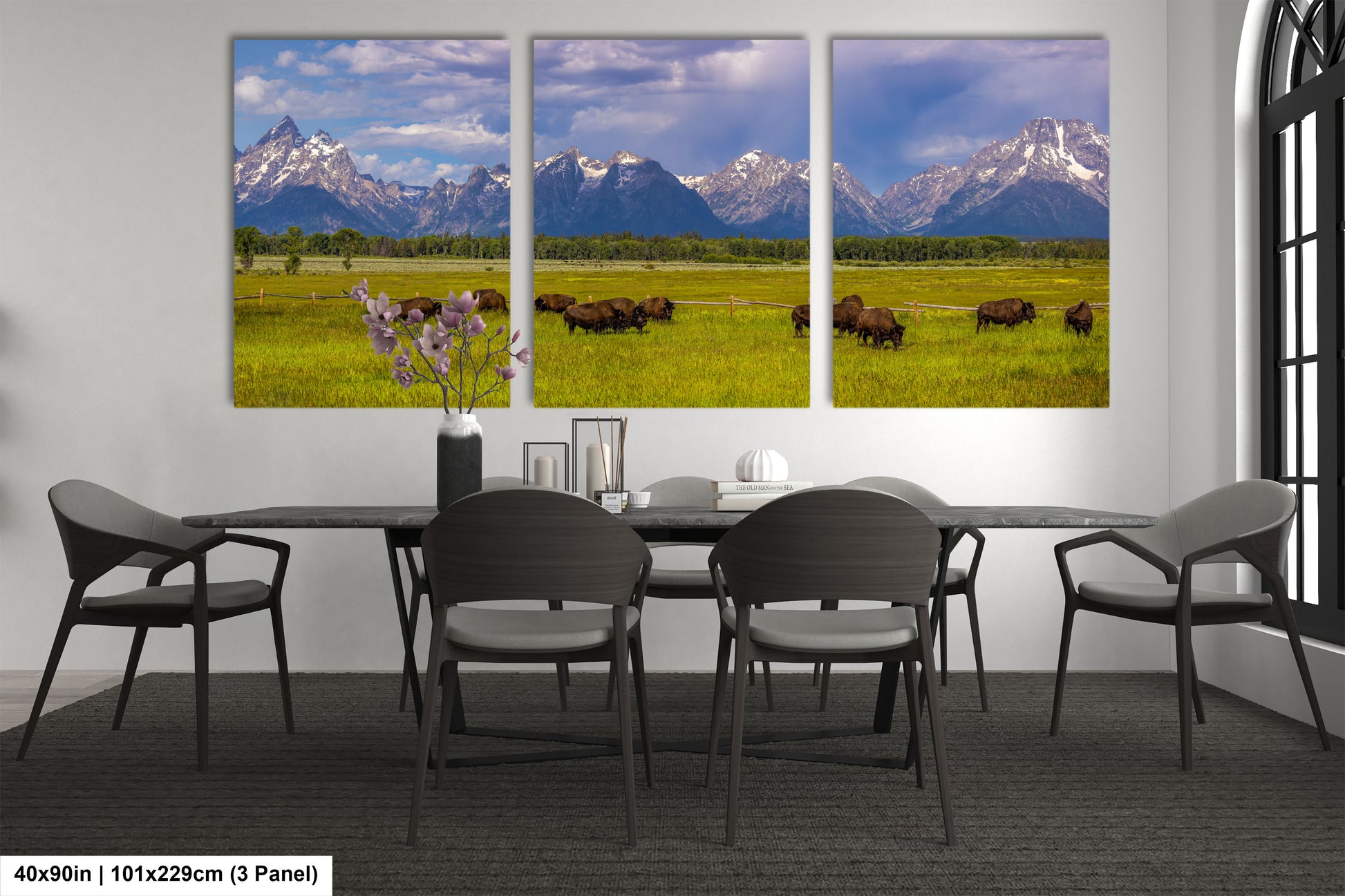a dining room table with four chairs and three pictures of bison