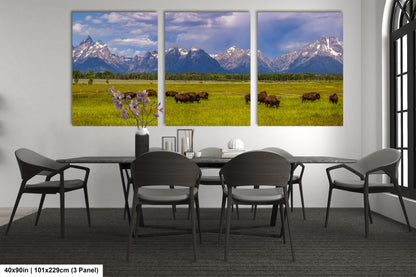 a dining room table with four chairs and three pictures of bison