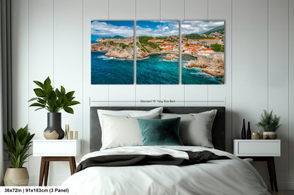 a bed room with a neatly made bed and a painting on the wall