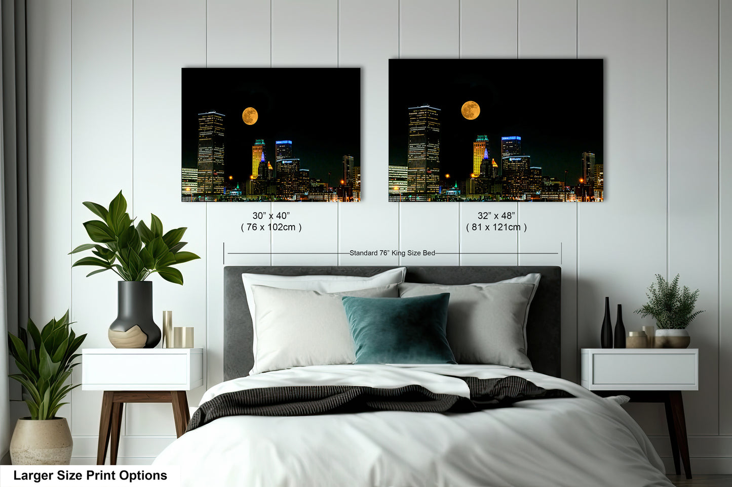 a bed with two pictures of a city at night