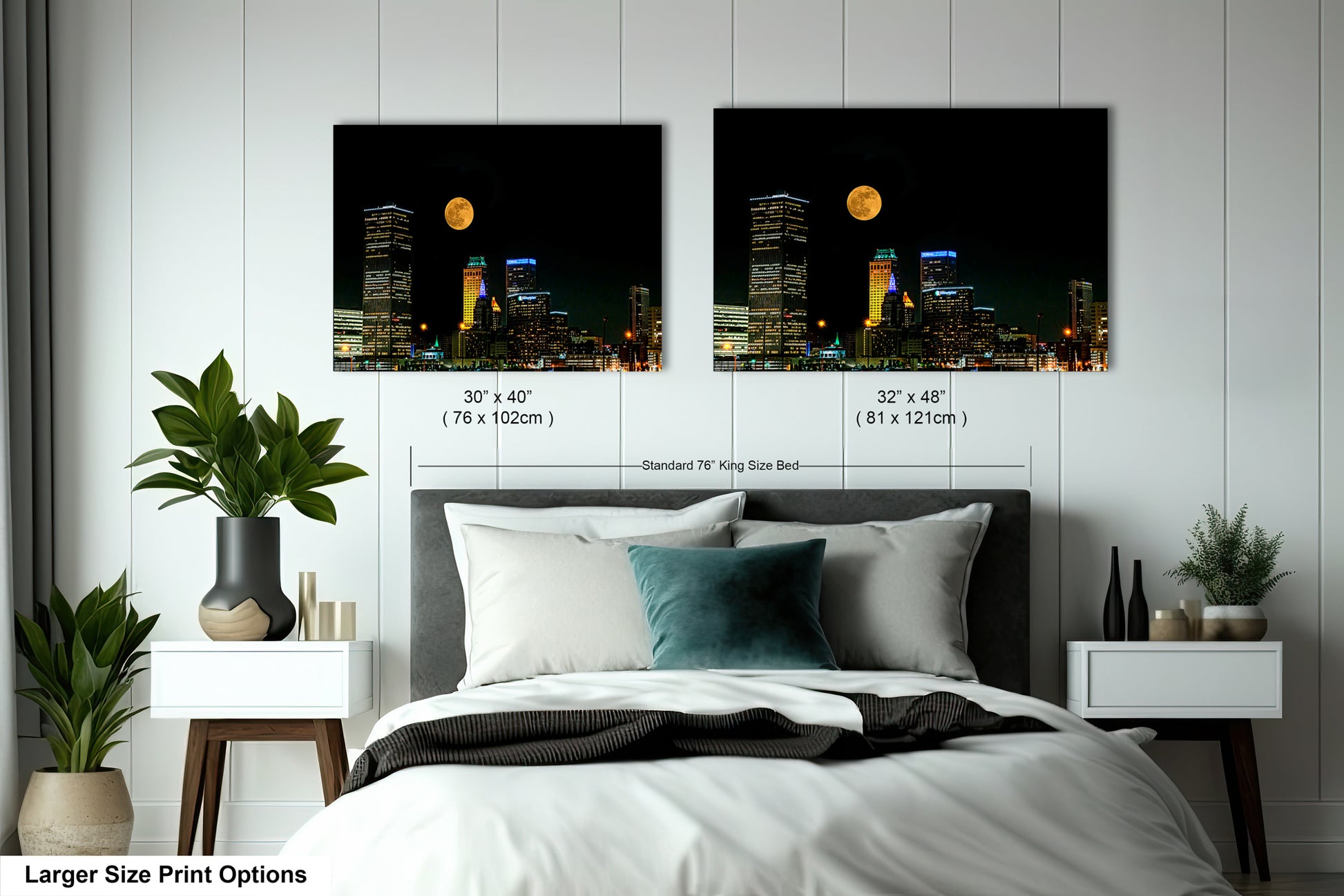 a bed with two pictures of a city at night