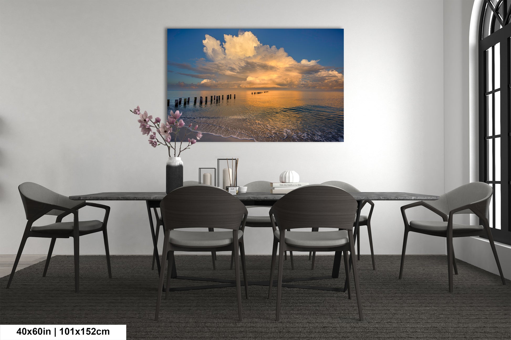 a dining room table with chairs and a painting on the wall
