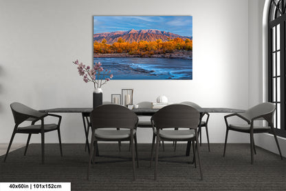 a dining room table with chairs and a painting on the wall